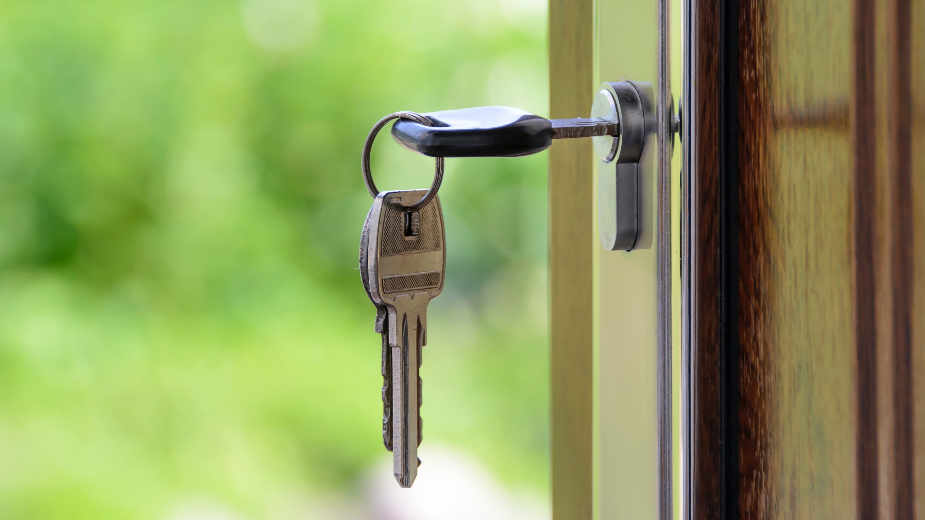 Close up image of keys in a door of a new home bought by first time homebuyers with Ownify