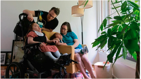 Jen, Evan, and their disabled children in their new home